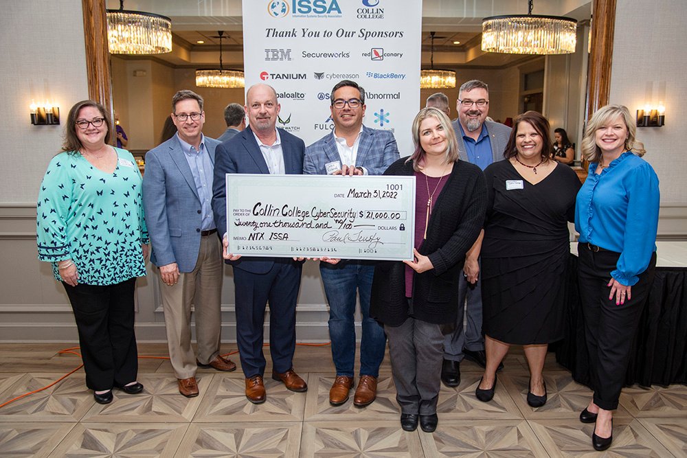 Representatives from Collin College joined members of the North Texas Information Security Systems Association for a photo after announcing a $21,000 donation to the Collin College Foundation.
